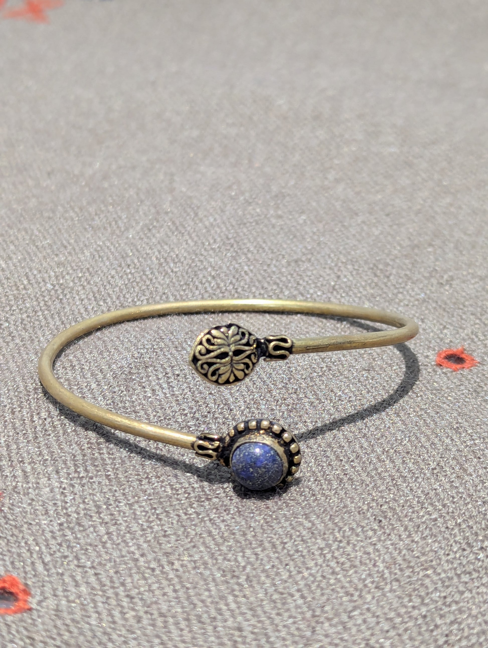 This stunning Oxidized Gold Adjustable Bracelet features a paddle and dome shape clasp ends. The speckled blue stone is reminiscent of the celestial moon and star constellations. Why not add a bit of glitz to your wrist or gift a special gift to the one's you love. 