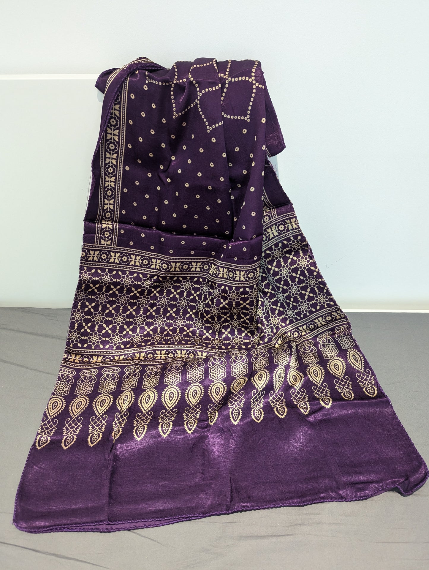 This richly detailed Block Printed Ajrakh scarf or summer shawl with gold gemoetric motifs and abstract floral motifs adds a splash to your attire. The rich eggplant purple hues add a depth of luxe to your outfit! 